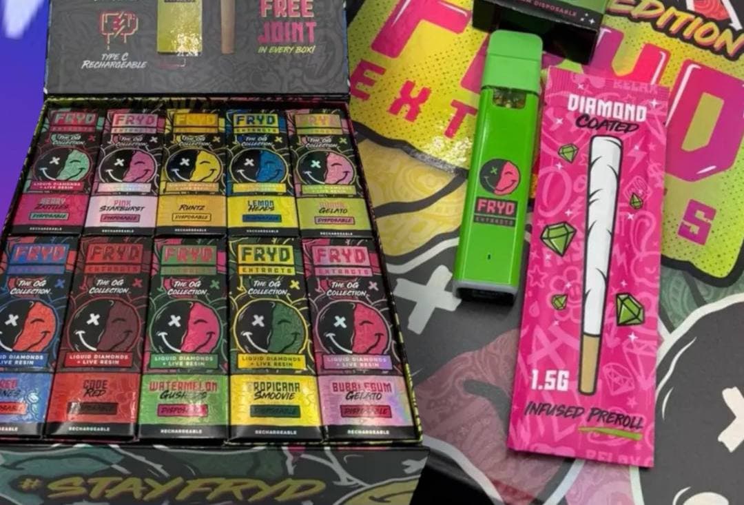 Colorful FRYD Extracts disposable vape pens in a display box with an infused preroll.